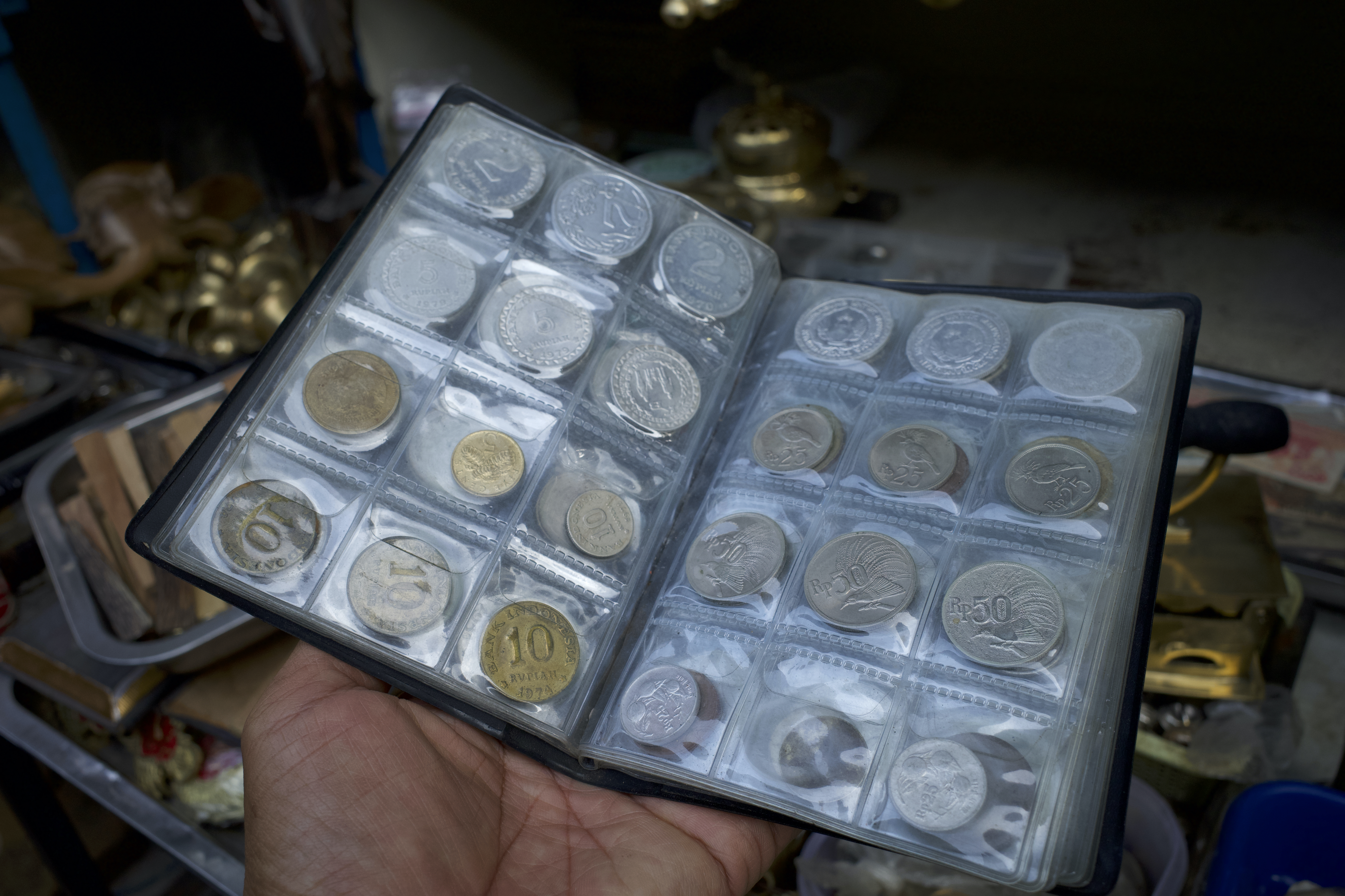 Collection of old coins, Indonesian money, old Rupiah in a collection book.